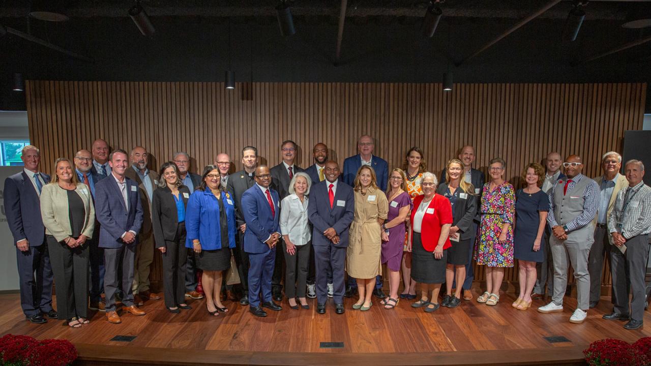 Danielle White on stage with other education recipients.