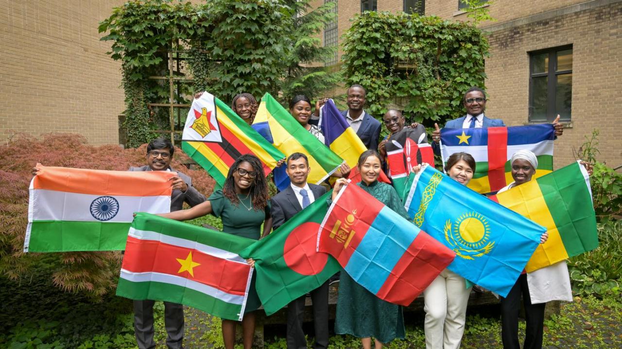 11 Cornell International Humphrey Fellows pose with their national flags