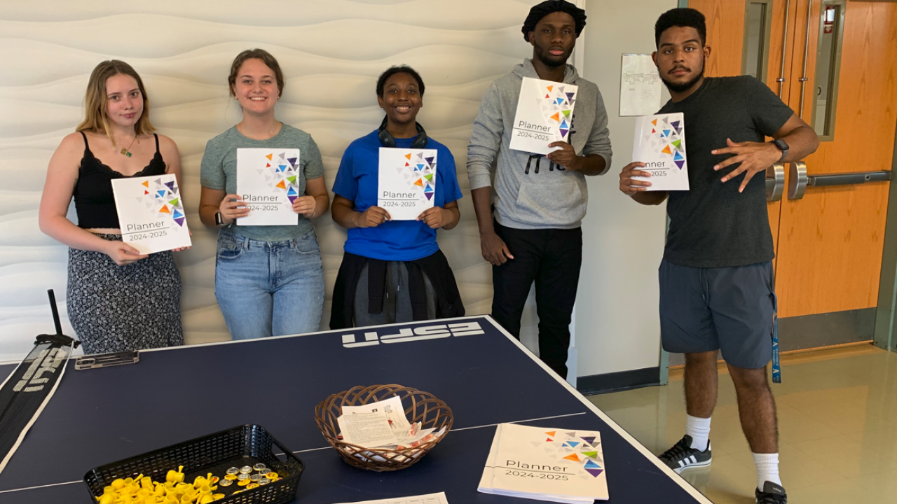 Peer mentors pictured with free planners in Burdick Hall