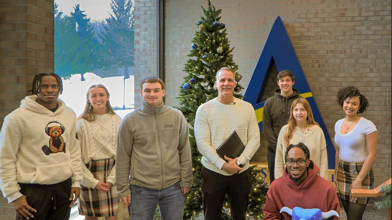 Students around the Christmas tree