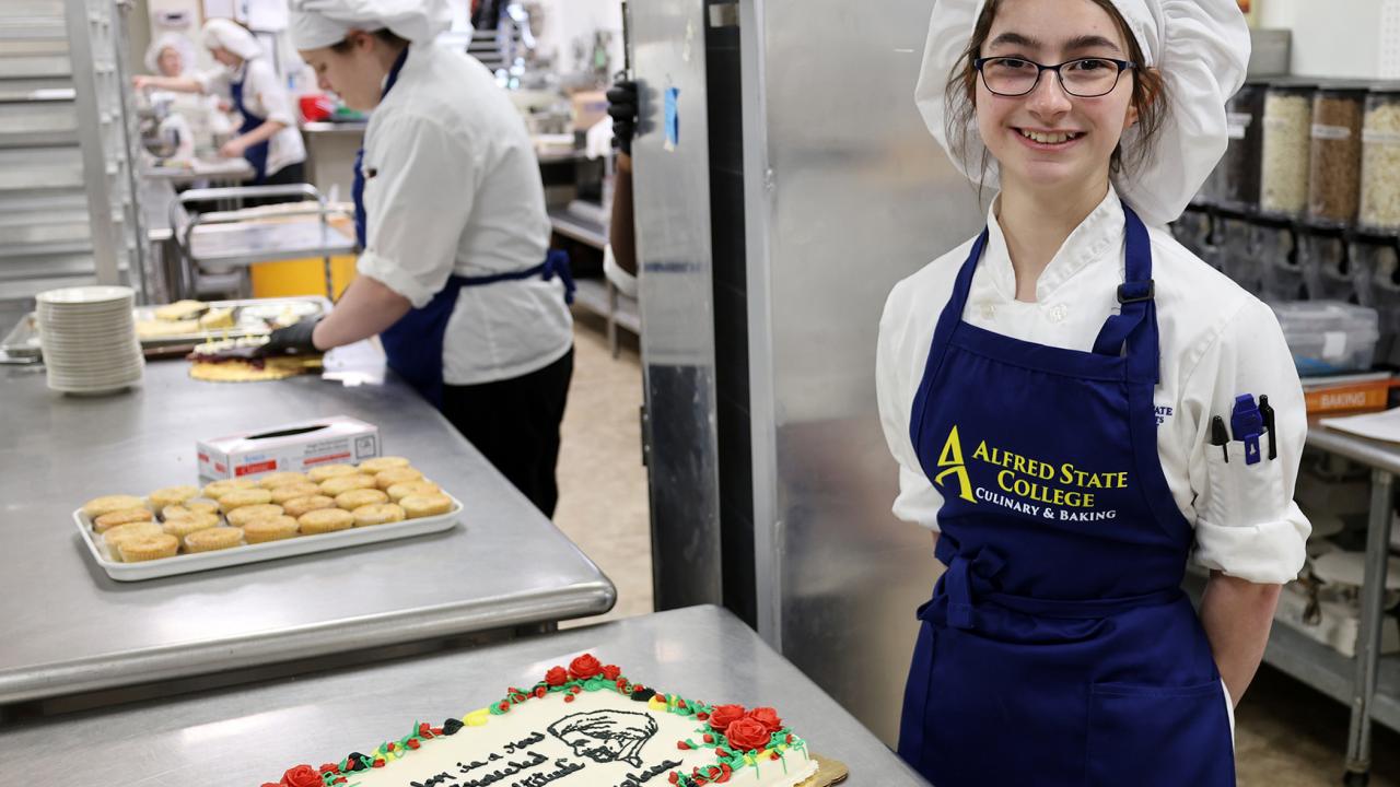 student displays her Frederick Douglass Day cake