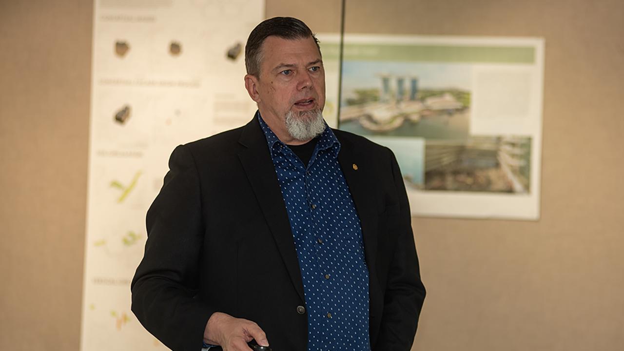 Bill Dean speaks to his class
