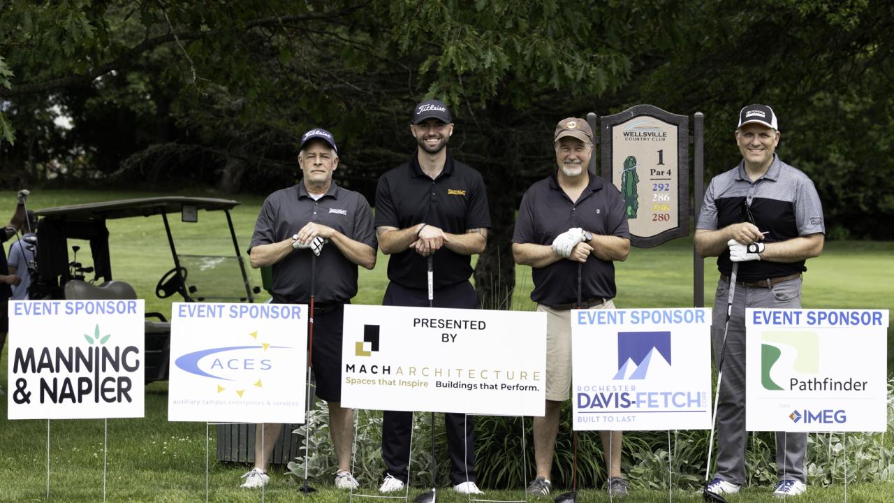 Golf Tournament champions behind all the major sponsor signs