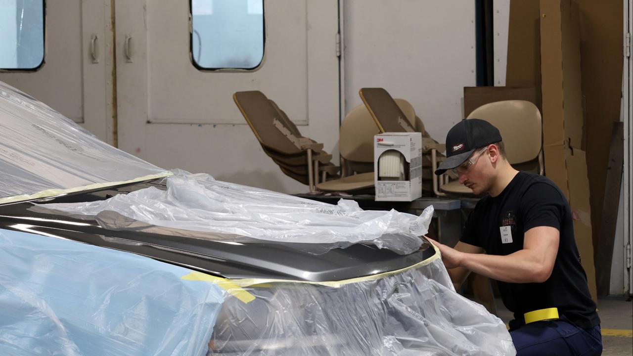 student works on an autobody project