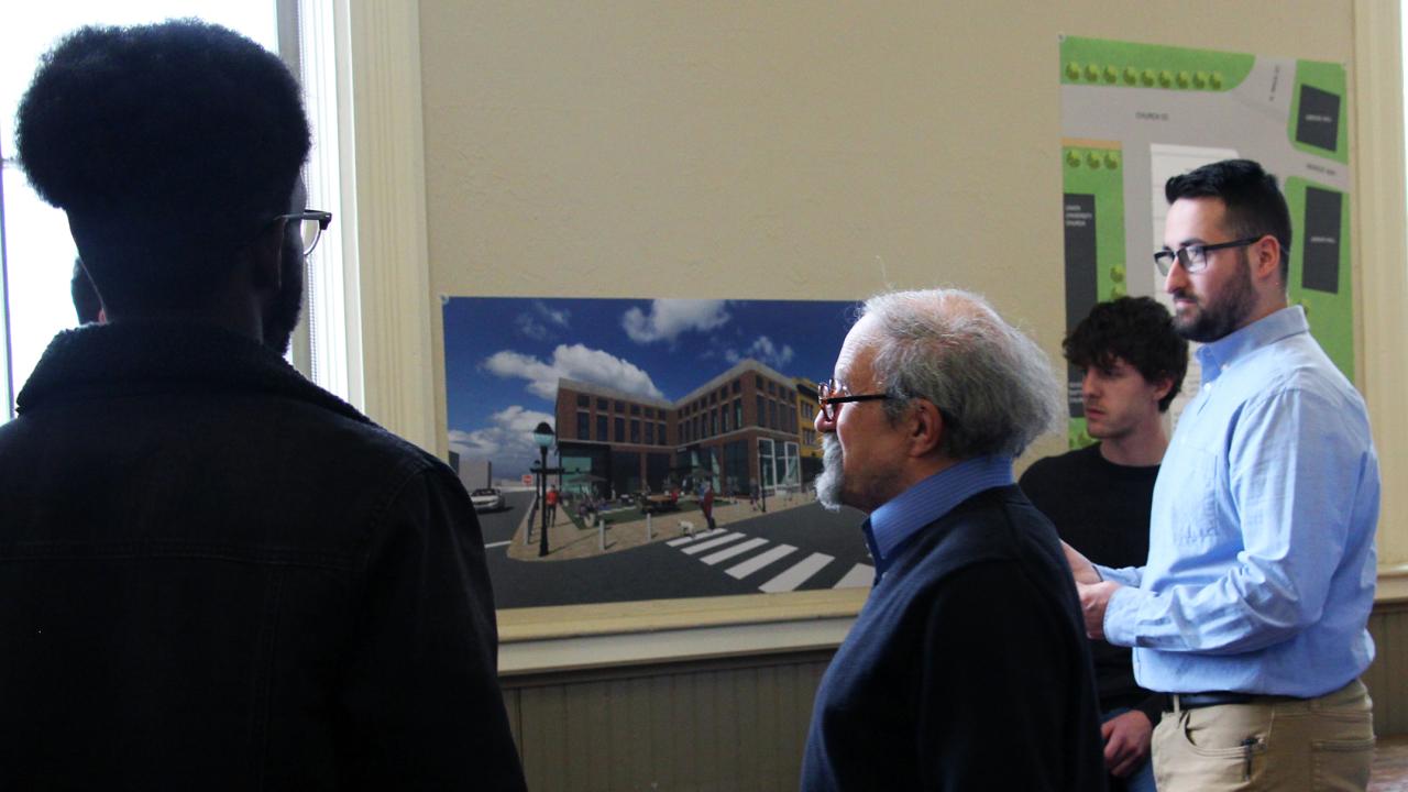 Architecture students speak with community members