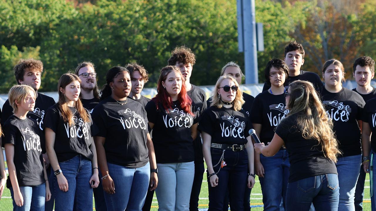 students sing the national anthem