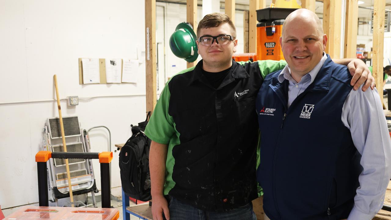 Aaron DeBolt and his son in a HVAC lab