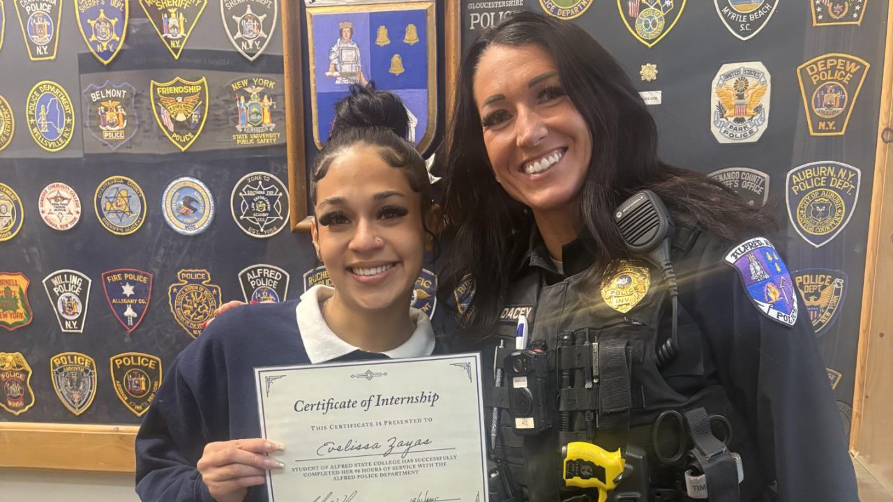 student poses with her mentor